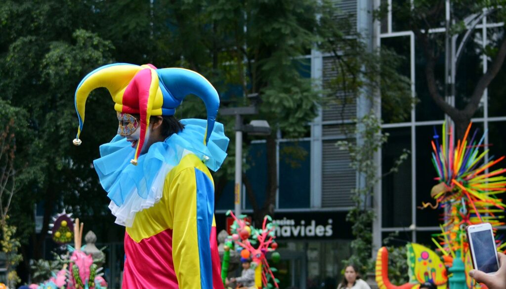 man in yellow and white long sleeve shirt holding yellow blue and red inflatable balloons