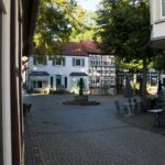 a courtyard with a fountain in the middle of it