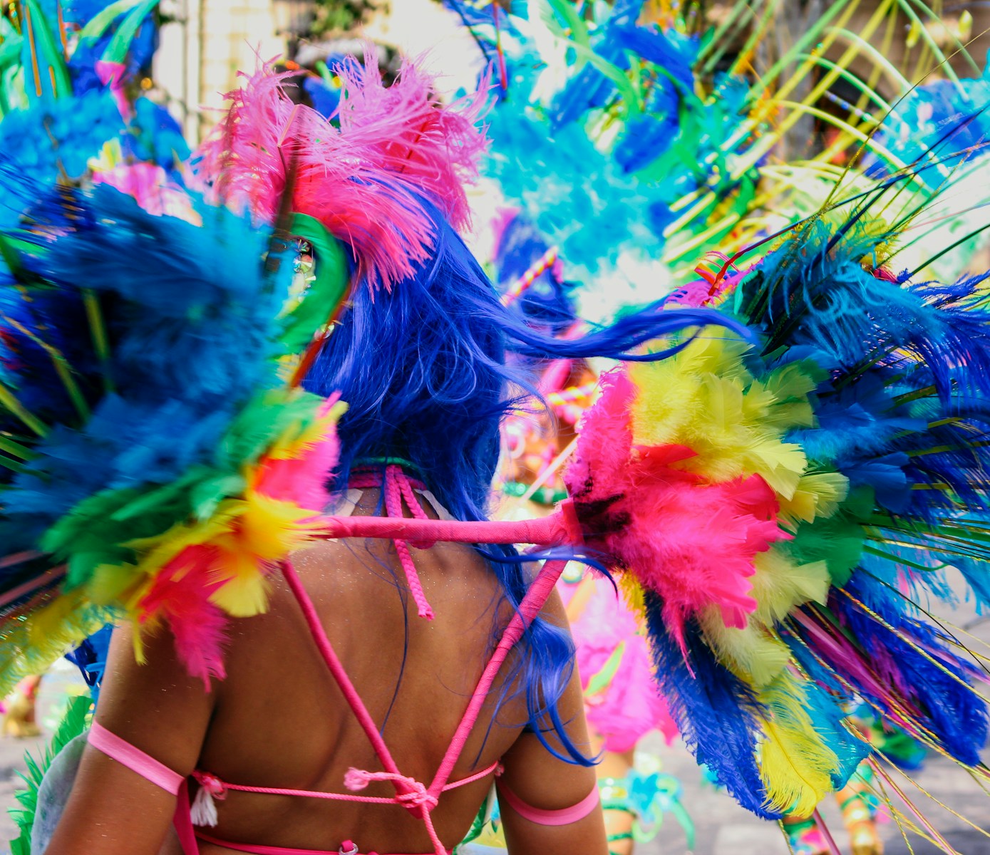 a woman wearing a colorful headdress in a parade